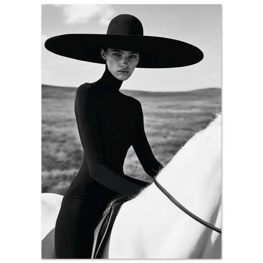 Striking black and white portrait of a woman in a black dress and wide hat seated on a white horse in an open landscape, exuding minimalist fashion elegance.